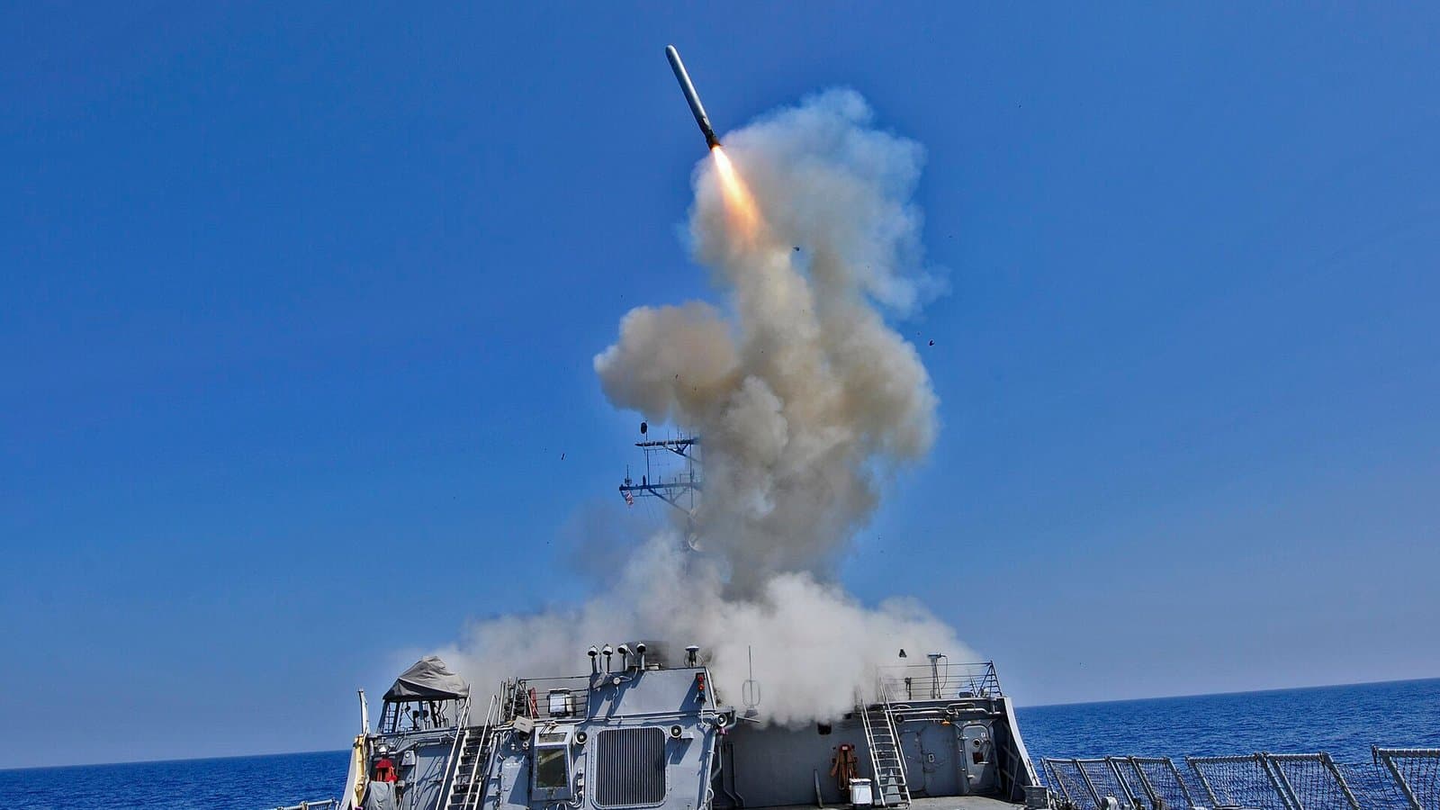The Arleigh Burke-class destroyer USS Barry launches a Tomahawk cruise missile from its deck