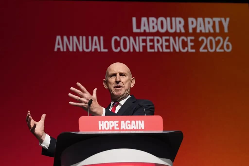 UK Treasury chief John Healey gesturing while speaking at a podium reading 'Hope Again' at the Labour Party Annual Conference 2026
